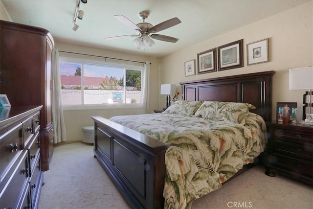 4433 E Justice Cir, Orange, CA 92869 - bedroom with rail lighting, light carpet, and a ceiling fan