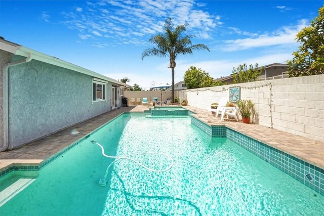 4433 E Justice Cir, Orange, CA 92869 - view of swimming pool with a patio area, a pool with connected hot tub, and a fenced backyard