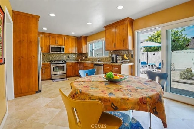 4433 E Justice Cir, Orange, CA 92869 - kitchen with brown cabinets, recessed lighting, appliances with stainless steel finishes, and decorative backsplash