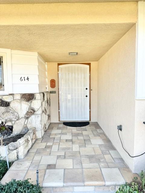 entrance to property featuring stucco siding