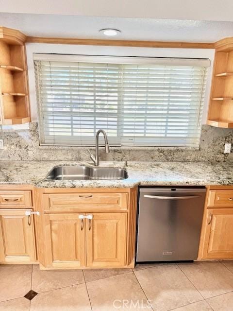 kitchen featuring open shelves, stainless steel dishwasher, light brown cabinetry, and a sink