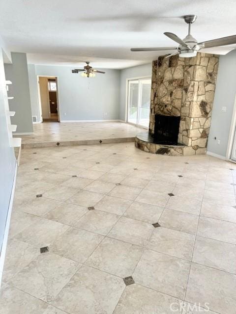 unfurnished living room featuring a ceiling fan, baseboards, tile patterned floors, and a fireplace