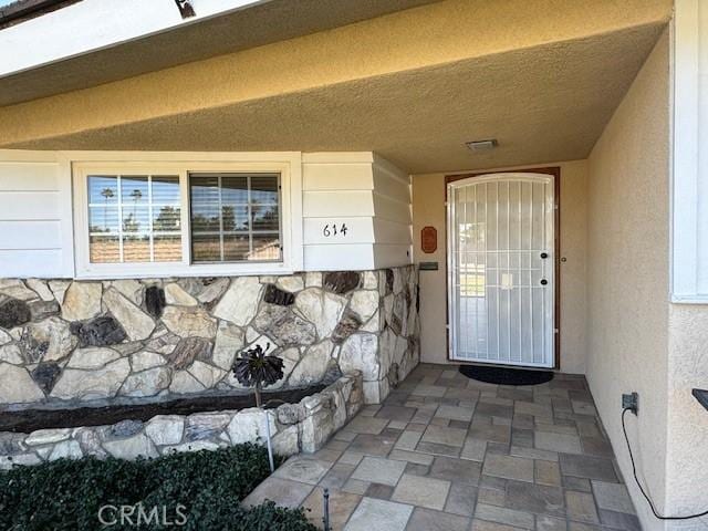 doorway to property with stucco siding