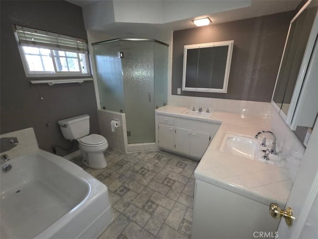 full bath with double vanity, a stall shower, and a sink