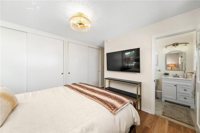 1614 Amelia Ave, San Pedro, CA 90731 - bedroom with two closets, wood finished floors, a sink, and ensuite bath