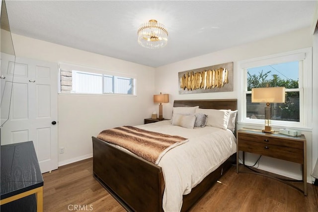 1614 Amelia Ave, San Pedro, CA 90731 - bedroom with wood finished floors, multiple windows, and a chandelier
