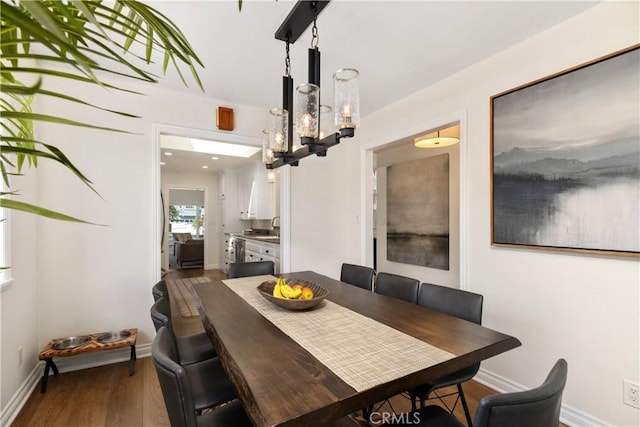 1614 Amelia Ave, San Pedro, CA 90731 - dining room with dark wood-type flooring, a chandelier, and baseboards
