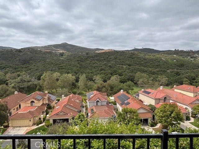 birds eye view of property with a residential view, a view of trees, and a mountain view