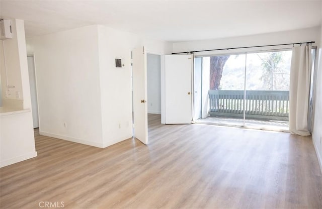 empty room featuring baseboards and light wood-style floors