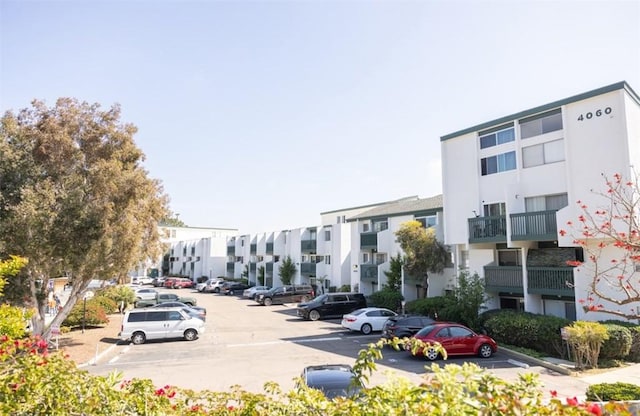 uncovered parking lot featuring a residential view