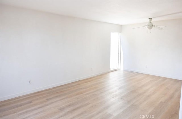 unfurnished room with baseboards, a ceiling fan, and light wood finished floors