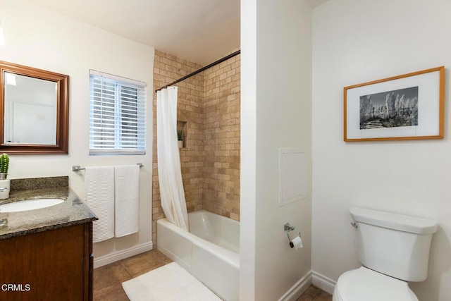bathroom featuring tile patterned flooring, baseboards, vanity, toilet, and shower / bath combo with shower curtain