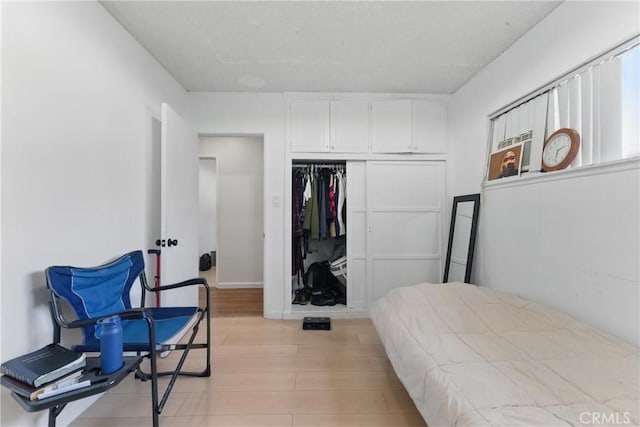 bedroom featuring a closet and light wood finished floors
