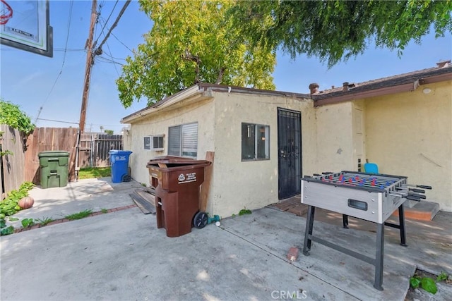 exterior space with a patio, fence, and stucco siding