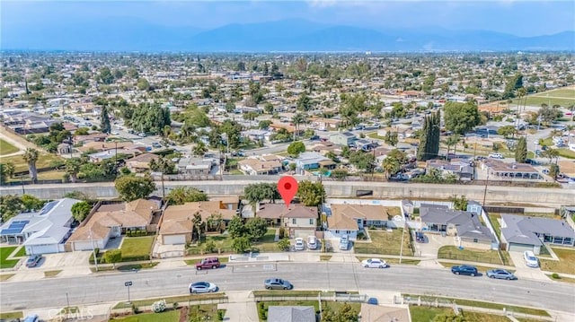 drone / aerial view featuring a residential view and a mountain view