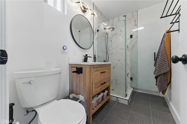 full bathroom with vanity, a marble finish shower, tile patterned flooring, and toilet
