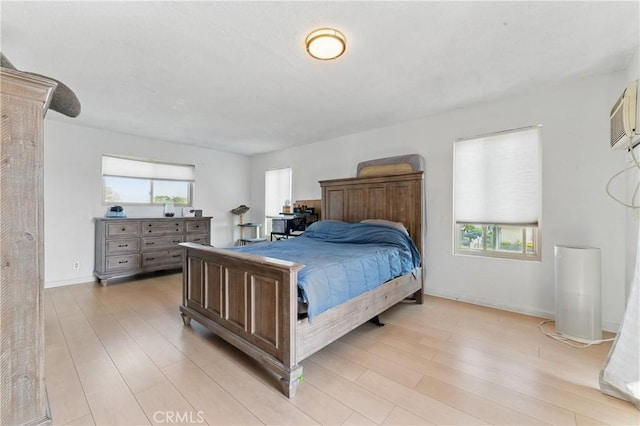 bedroom with light wood-type flooring and baseboards