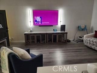 living area featuring baseboards and wood finished floors