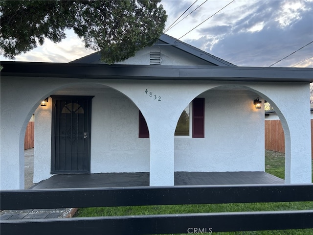 entrance to property featuring stucco siding