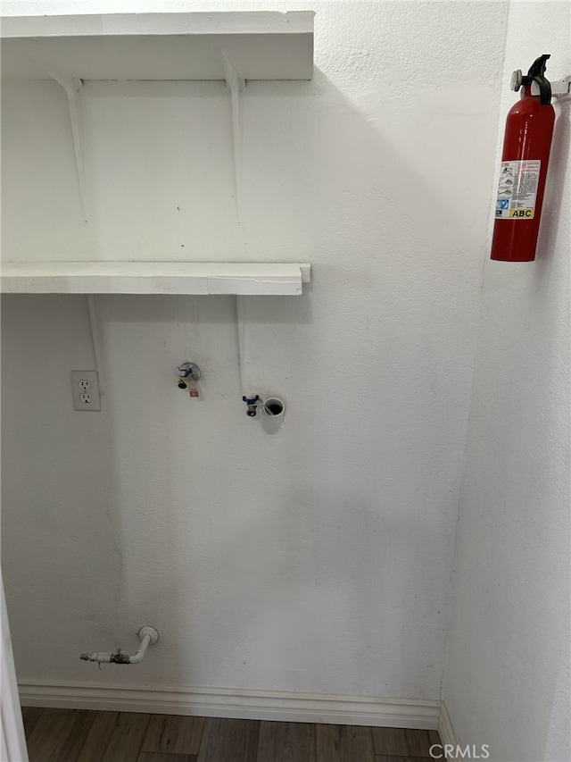 laundry room featuring wood finished floors and baseboards