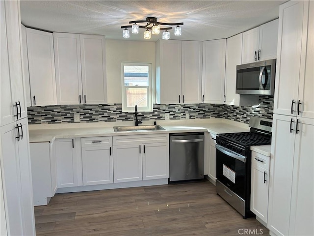 4832 Mitchell Ave, Riverside, CA 92505 - kitchen with stainless steel appliances, tasteful backsplash, white cabinetry, light countertops, and a textured ceiling