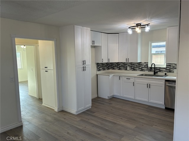 4832 Mitchell Ave, Riverside, CA 92505 - kitchen featuring dishwasher, tasteful backsplash, white cabinetry, wood finished floors, and light countertops
