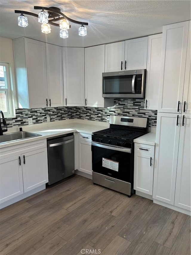 4832 Mitchell Ave, Riverside, CA 92505 - kitchen with stainless steel appliances, white cabinets, and a textured ceiling