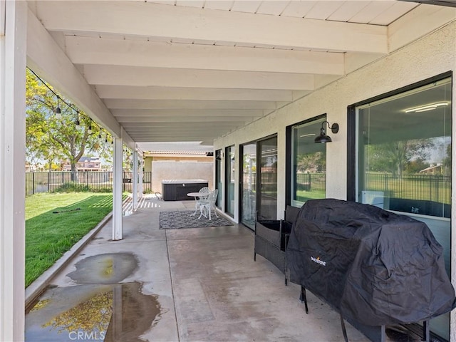 view of patio featuring area for grilling, a hot tub, and a fenced backyard