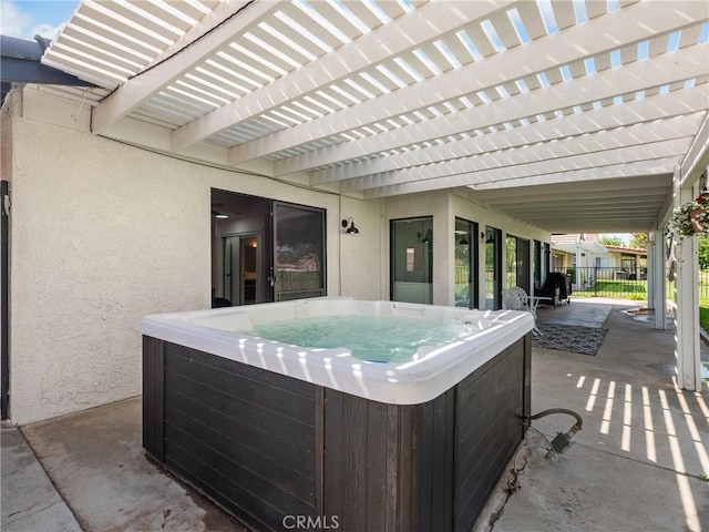 view of patio / terrace with fence, a pergola, and a hot tub