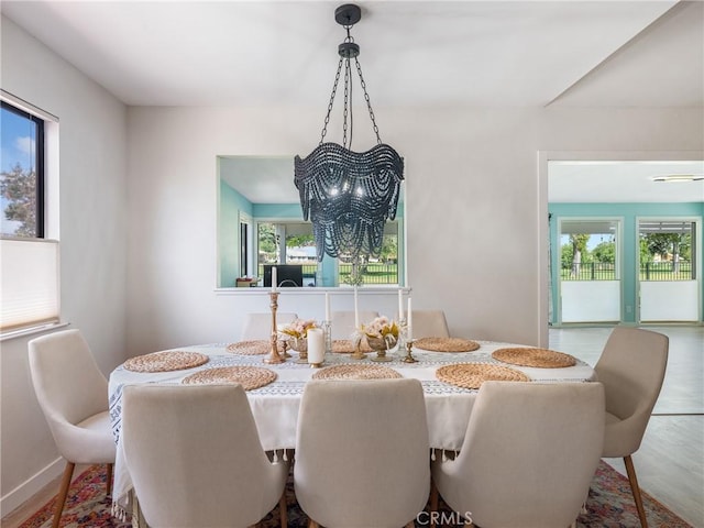 dining area featuring an inviting chandelier and a wealth of natural light