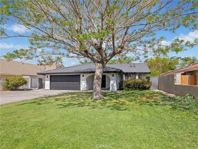 view of front of home with a garage, fence, a front yard, stucco siding, and a tile roof