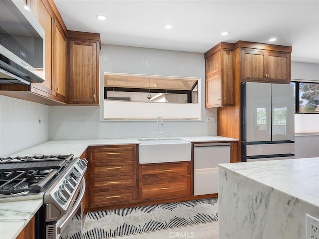kitchen with backsplash, recessed lighting, appliances with stainless steel finishes, and a sink
