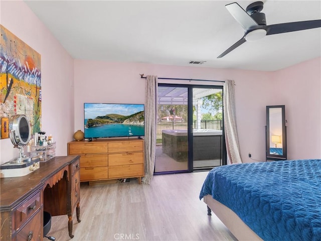 bedroom featuring ceiling fan, visible vents, access to exterior, and light wood-style floors