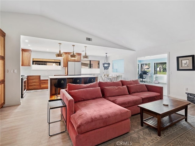 living room featuring light wood-style floors, recessed lighting, baseboards, lofted ceiling, and visible vents