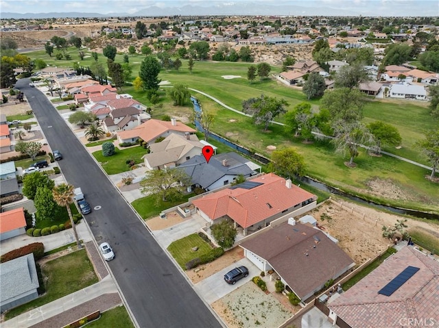 birds eye view of property with a residential view, a mountain view, and view of golf course