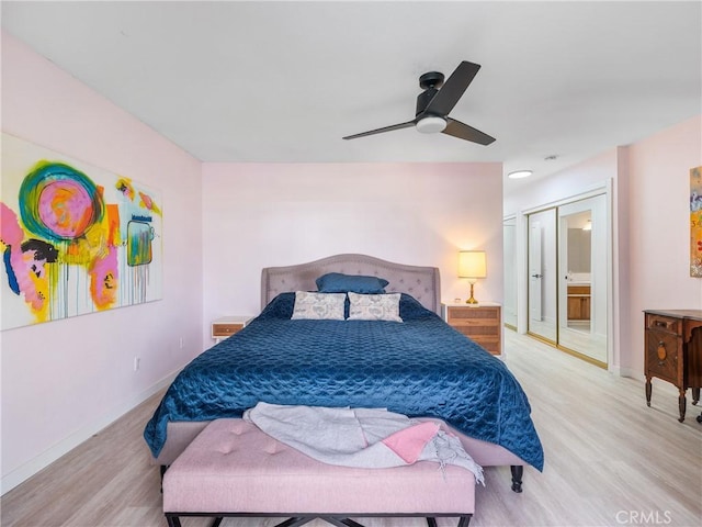 bedroom with light wood-style floors, baseboards, and ceiling fan