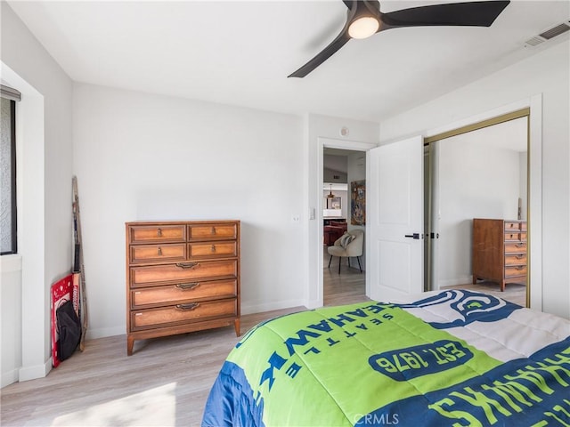 bedroom featuring light wood-style floors, baseboards, ceiling fan, and visible vents