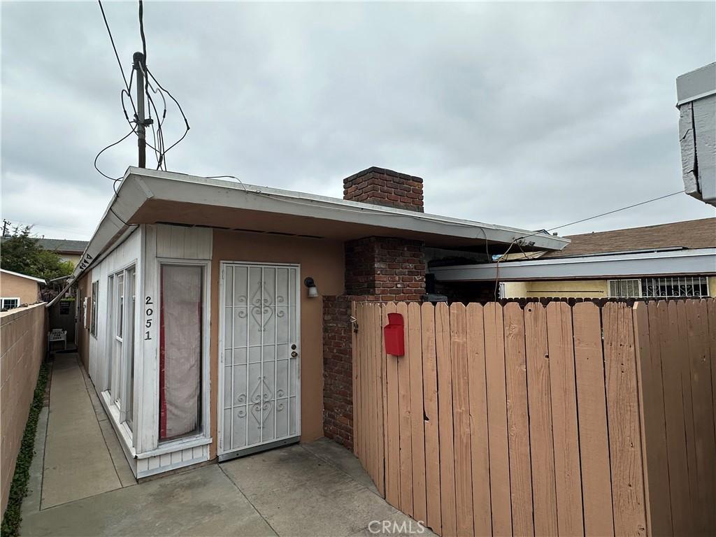 exterior space with fence and a chimney