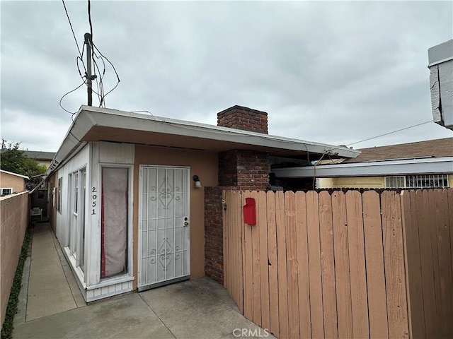 exterior space with fence and a chimney