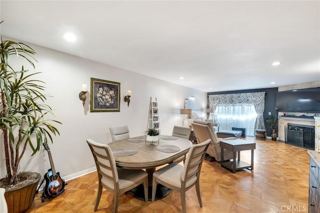 dining area featuring recessed lighting, baseboards, and a fireplace with flush hearth