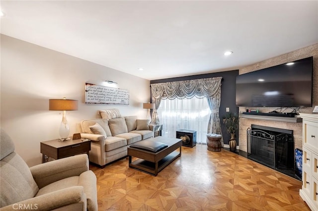 living area with recessed lighting and a fireplace