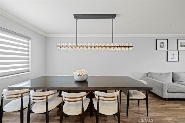 dining room featuring ornamental molding and wood finished floors