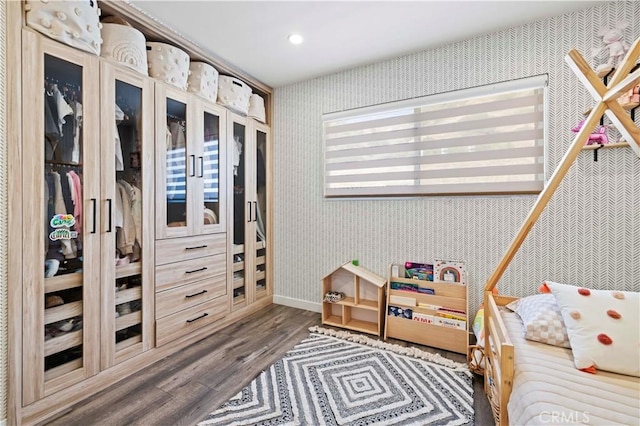 bedroom with recessed lighting, baseboards, wood finished floors, and wallpapered walls
