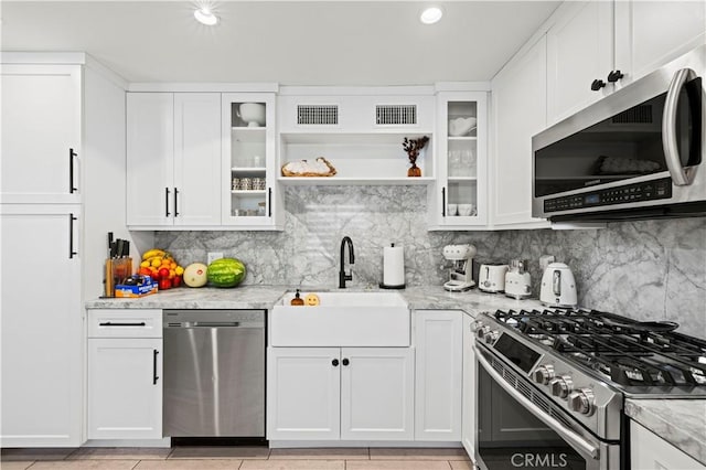 kitchen featuring visible vents, a sink, white cabinetry, and stainless steel appliances
