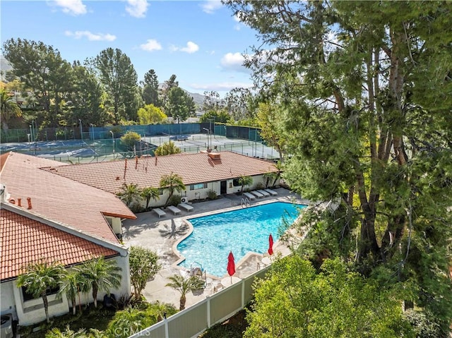 community pool featuring fence and a patio area