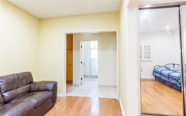 living area with baseboards and light wood finished floors