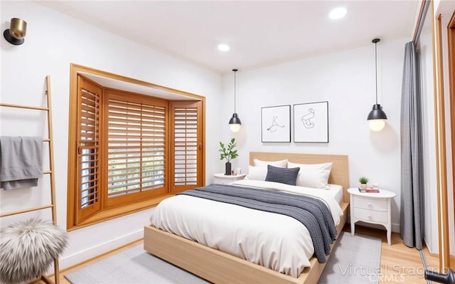 bedroom with light wood-style floors, recessed lighting, and baseboards