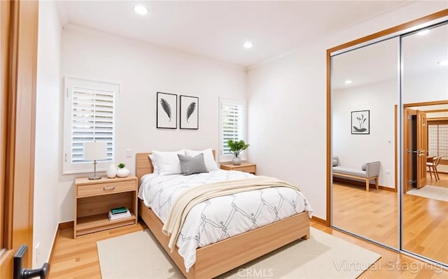 bedroom featuring a closet, baseboards, recessed lighting, and light wood-style floors