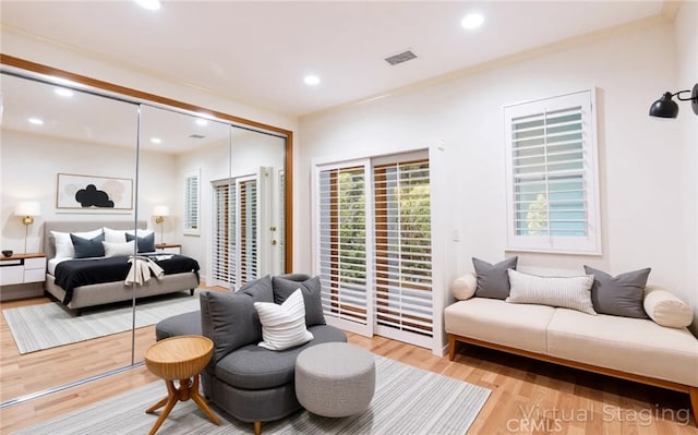bedroom with recessed lighting, access to outside, a closet, and light wood-type flooring