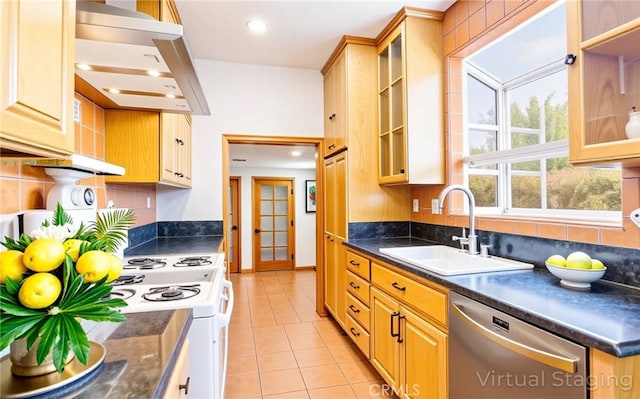 kitchen featuring a sink, dark countertops, decorative backsplash, and dishwasher